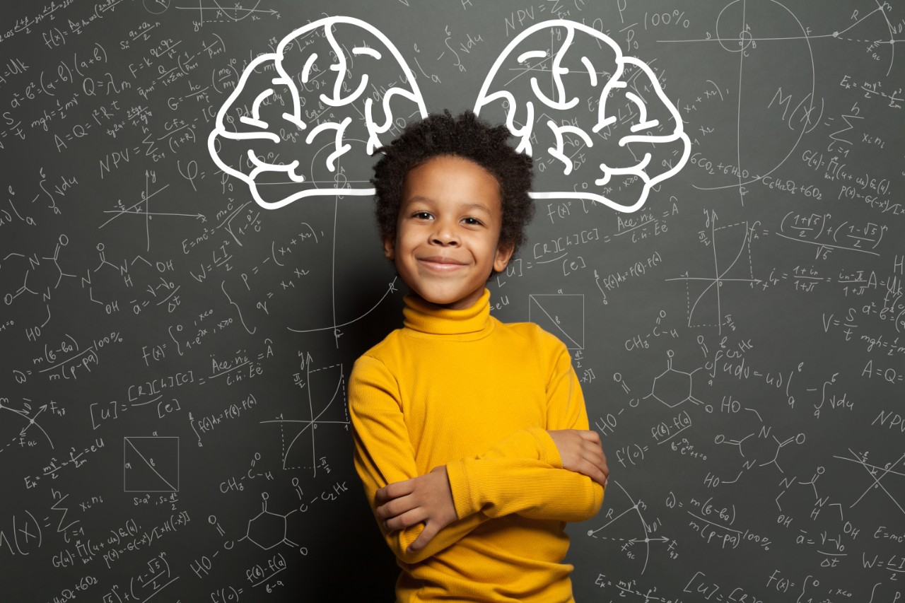 1257280887 Smiling black child with big brain and science formulas on black, education and brainstorming concept