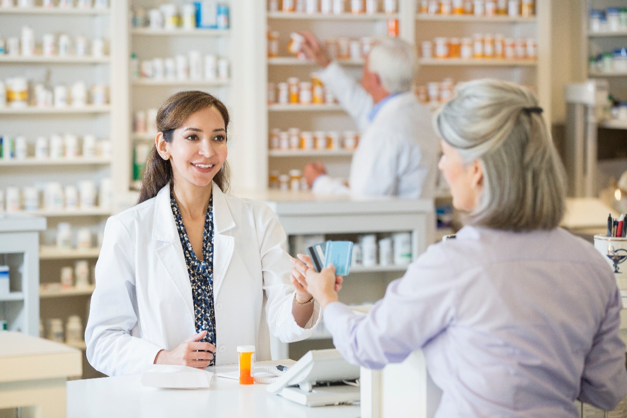 463247287 Pharmacist talking to customer