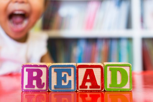 1145843759 Closeup of kids alphabet wooden blocks arranged to spell "read"