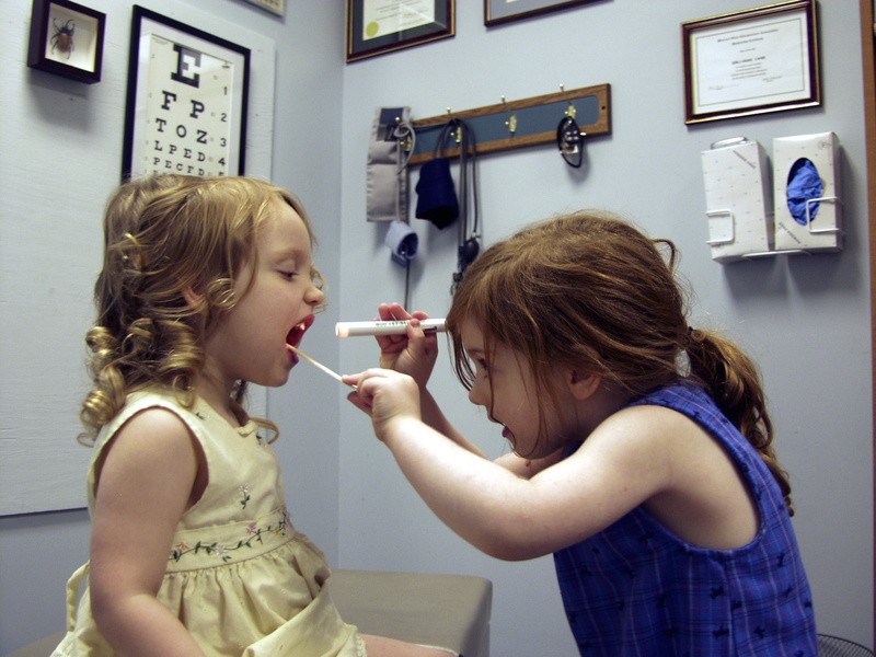 Two little girl's playing doctor