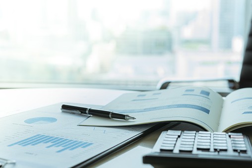 reports and calculator on desk