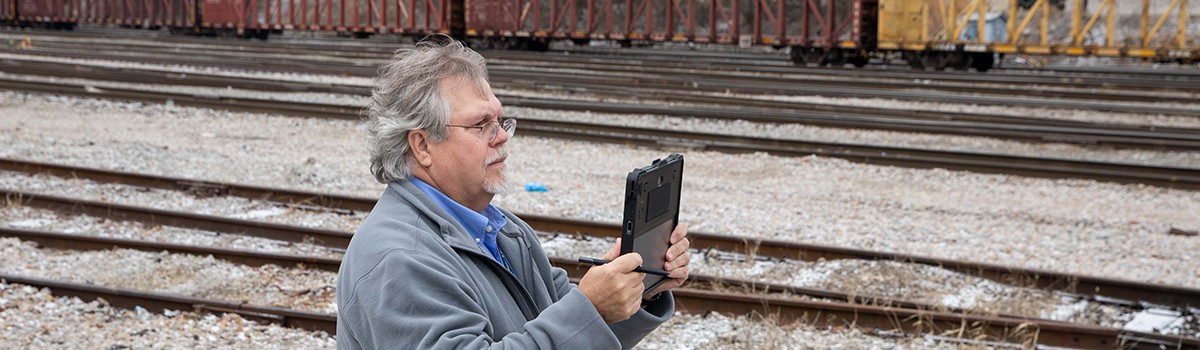 a man inspecting railroad tracks